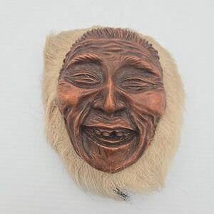 Vintage Alaskan Eskimo heads; fur trim wall hanging